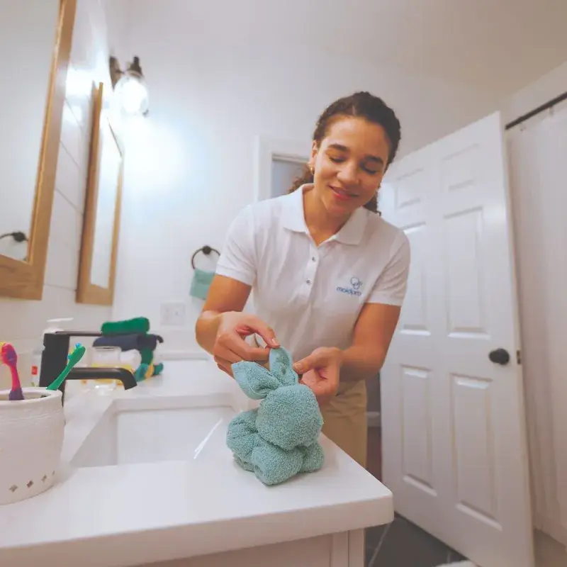 MaidPro cleaner adding a personal touch with a towel bunny